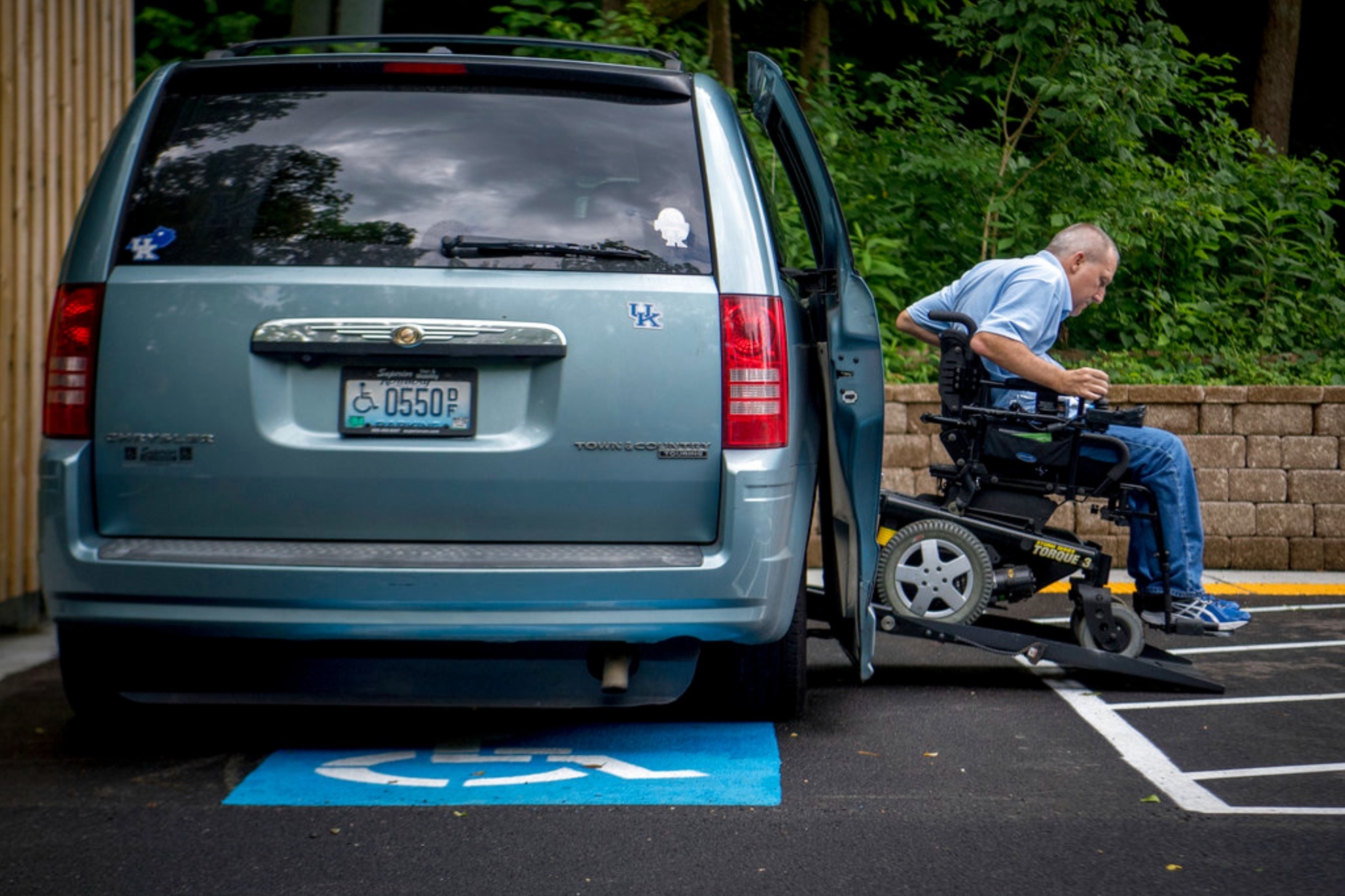 A person descends from a wheelchair-adapted mini van in Kentucky